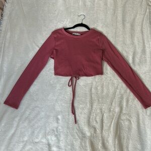 Soft pink ribbed long sleeve Fashion Nova crop top with partial open back